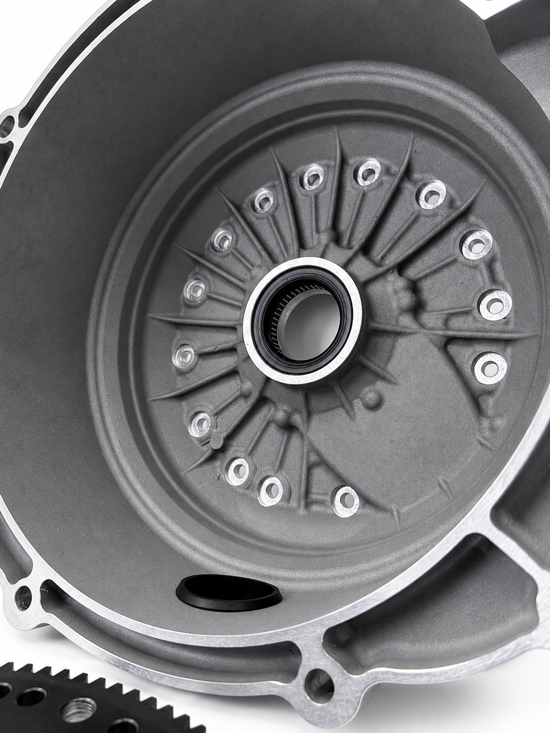 Superior bellhousing kit close-up, black inner plate with bolt pattern and center bushing