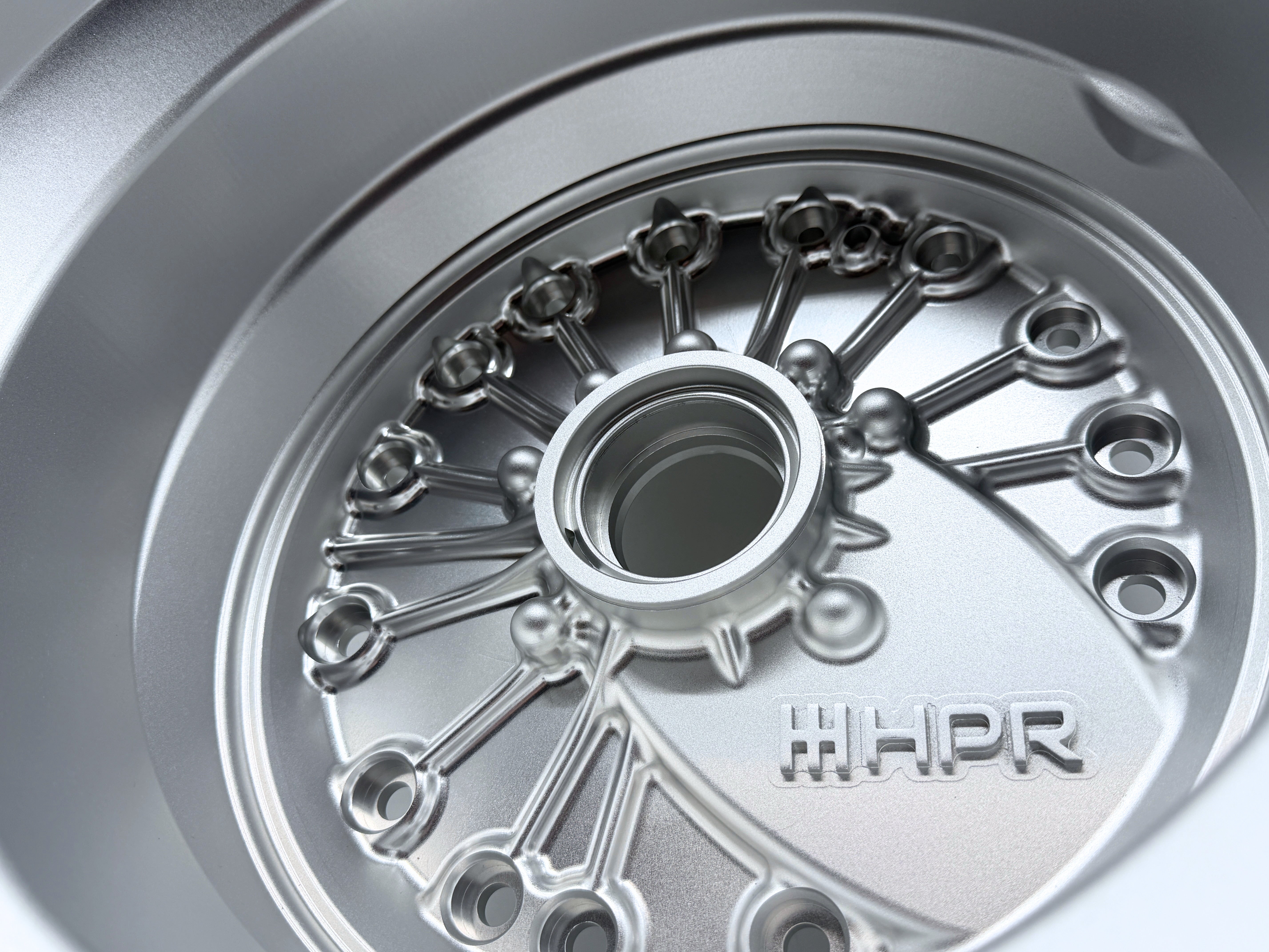 Machined metal bellhousing interior with bolt holes and HHP R emblem