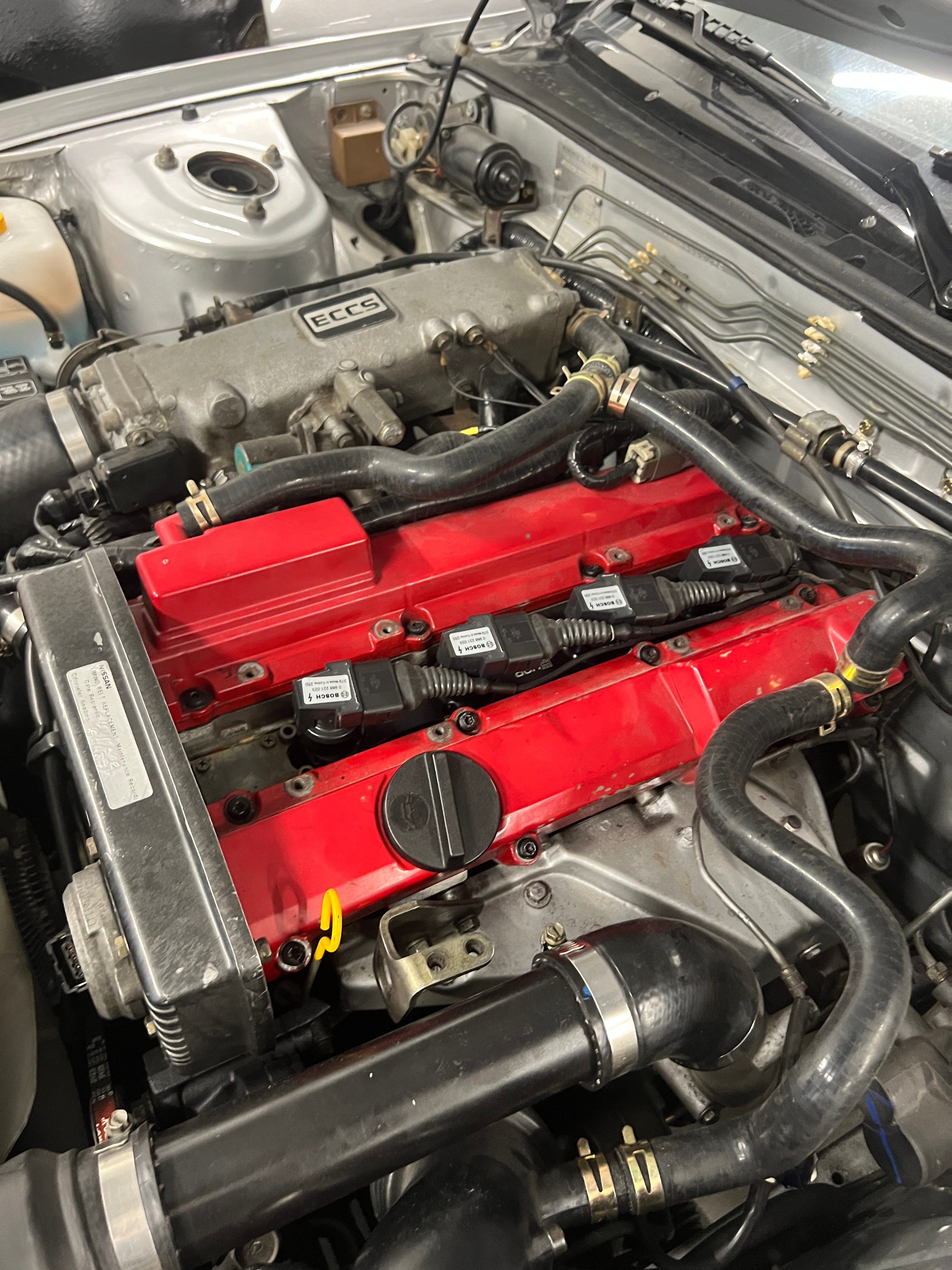 The HPR coil kit mounted into a Nissan CA18 engine, together with the ignition coils from Bosch, as well as the wiring harness.