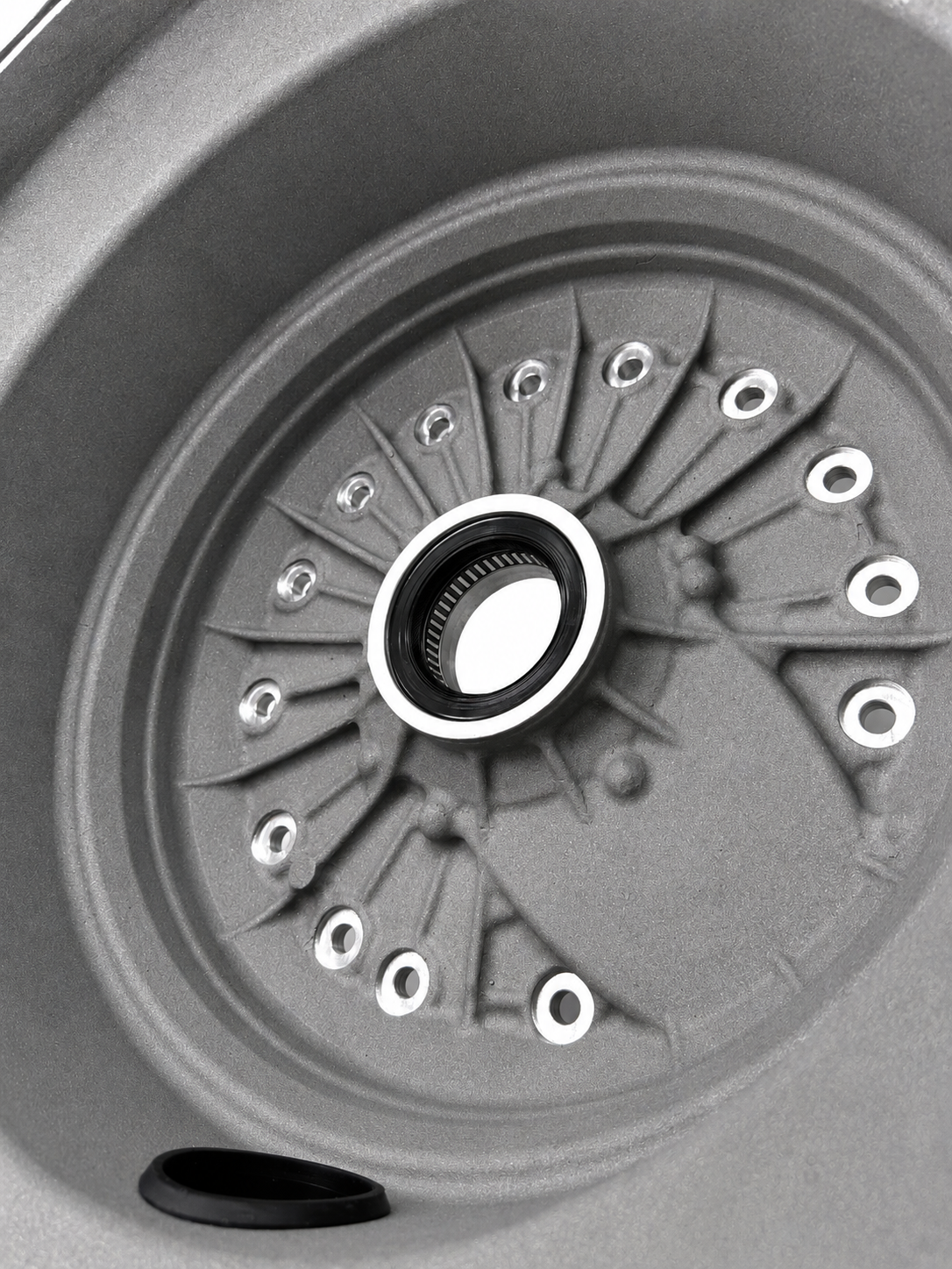 Close-up of bellhousing cover interior with central bearing opening and bolt points
