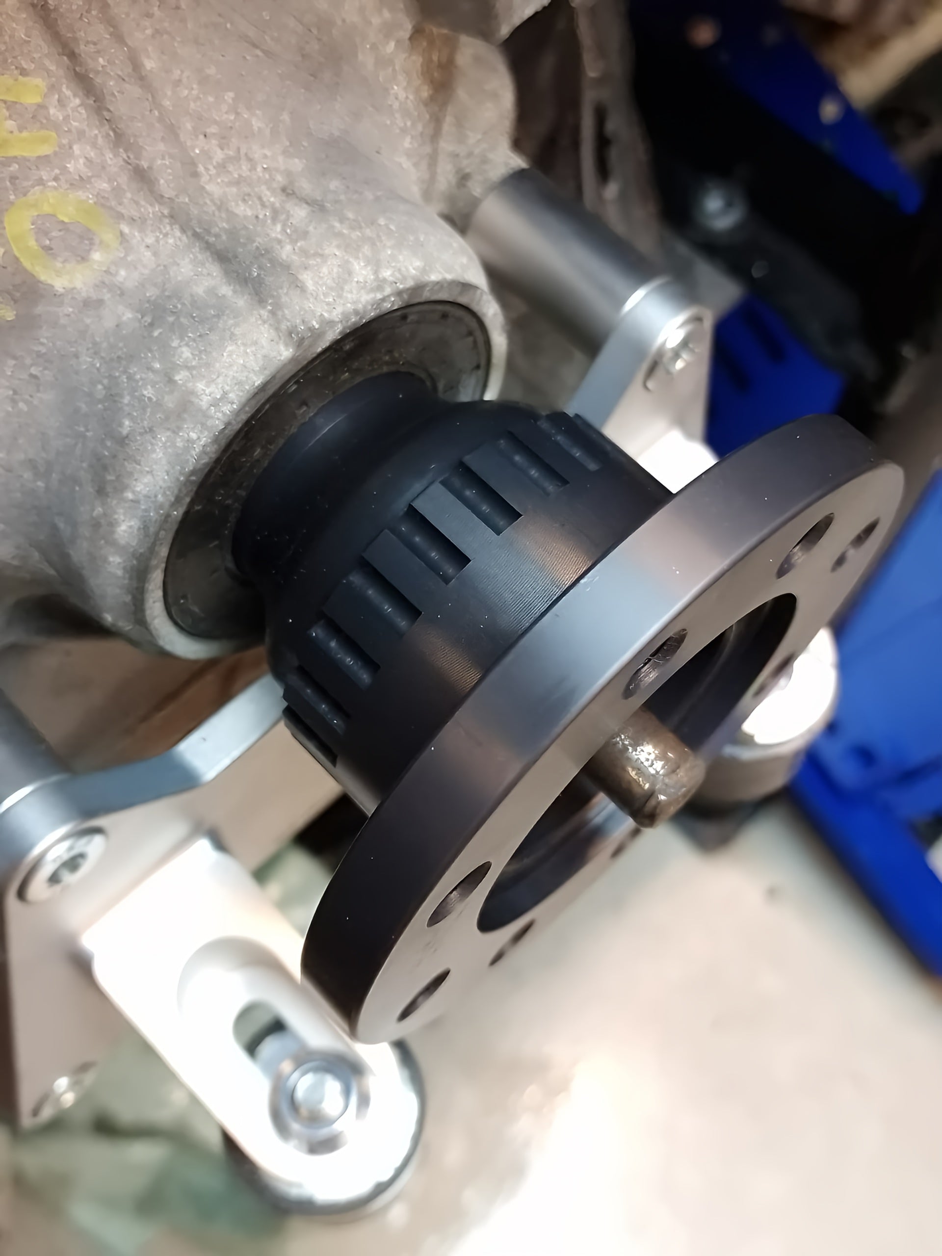 Metal wheel hub and flange component with mounting bolts and rubber bushing