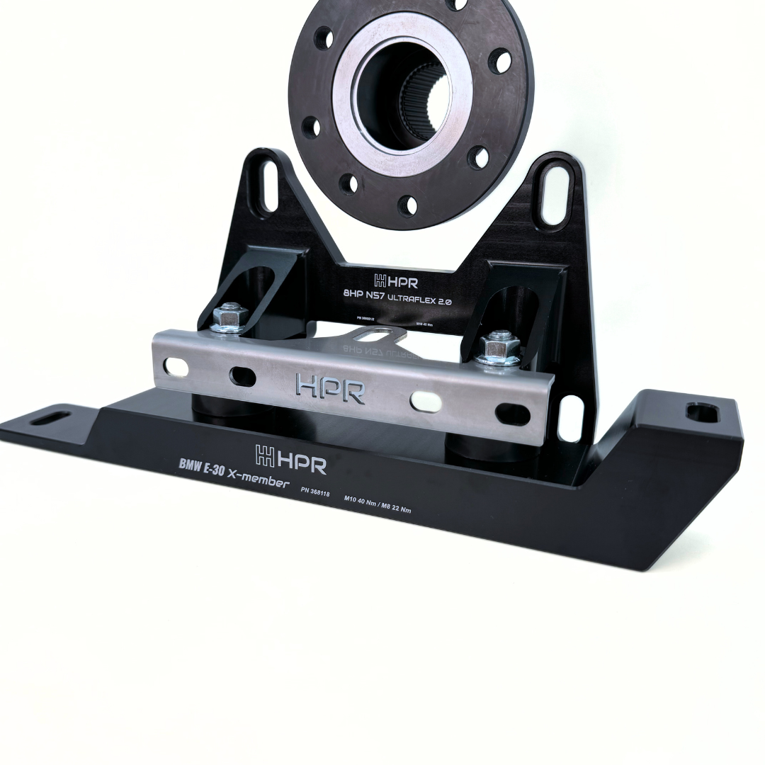 An aftermarket BMW E30 8HP conversion kit, featuring a black HPR billet aluminium crossmember and mounts.