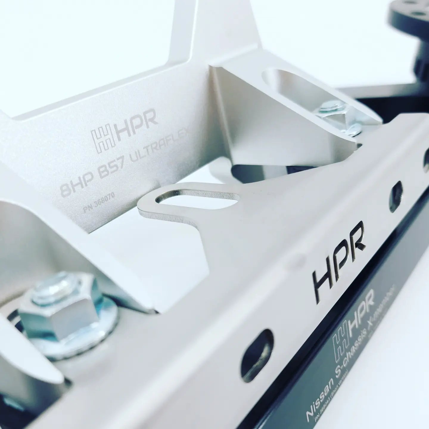 White chassis crossmember with HPR logo, mounting holes, and cutout openings